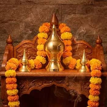 Kalasam ritual pot decorated with marigold garlands for temple Kumbabishekam ceremony